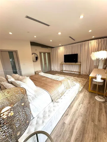 a bed room with a bed and a television