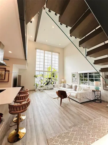 a living room with fireplace furniture and a large window