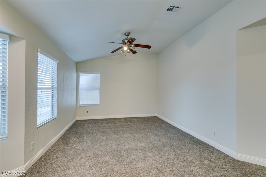 1738 Toltec Circle Henderson, NV 89014 - Photo 27 of 46 A quiet retreat, this bedroom offers vaulted ceilings and soft carpeting underfoot.
