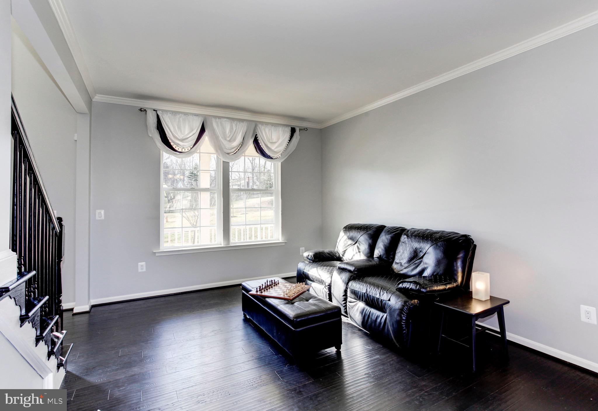 5952 Hunter Crest Road Woodbridge, VA 22193 - Photo 4 of 44 Living Room with crown molding & hardwood flooring