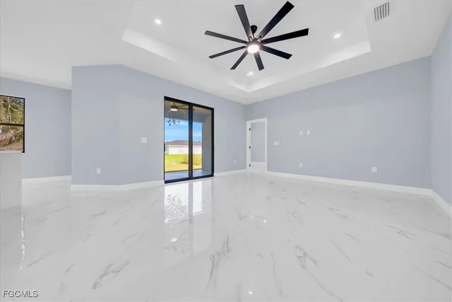 an empty room with fan and windows