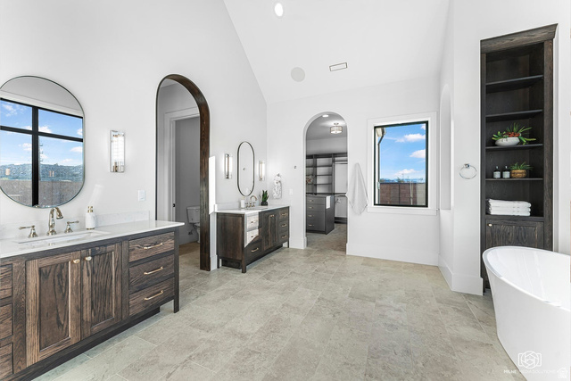 1468 South Red Cliffs Temple Lane St. George, UT 84790 - Photo 25 of 64 Bathroom featuring a freestanding tub, two vanities, lofted ceiling, and a spacious closet