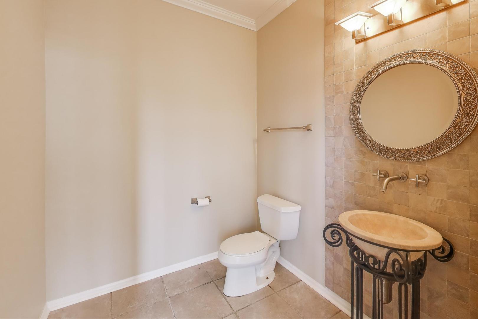 9699 Fairfield Road Huntley, IL 60142 - Photo 12 of 59 a bathroom with a toilet a sink and a mirror