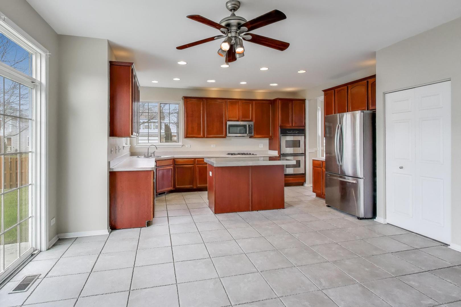 9699 Fairfield Road Huntley, IL 60142 - Photo 16 of 59 a kitchen with stainless steel appliances granite countertop a refrigerator sink and cabinets