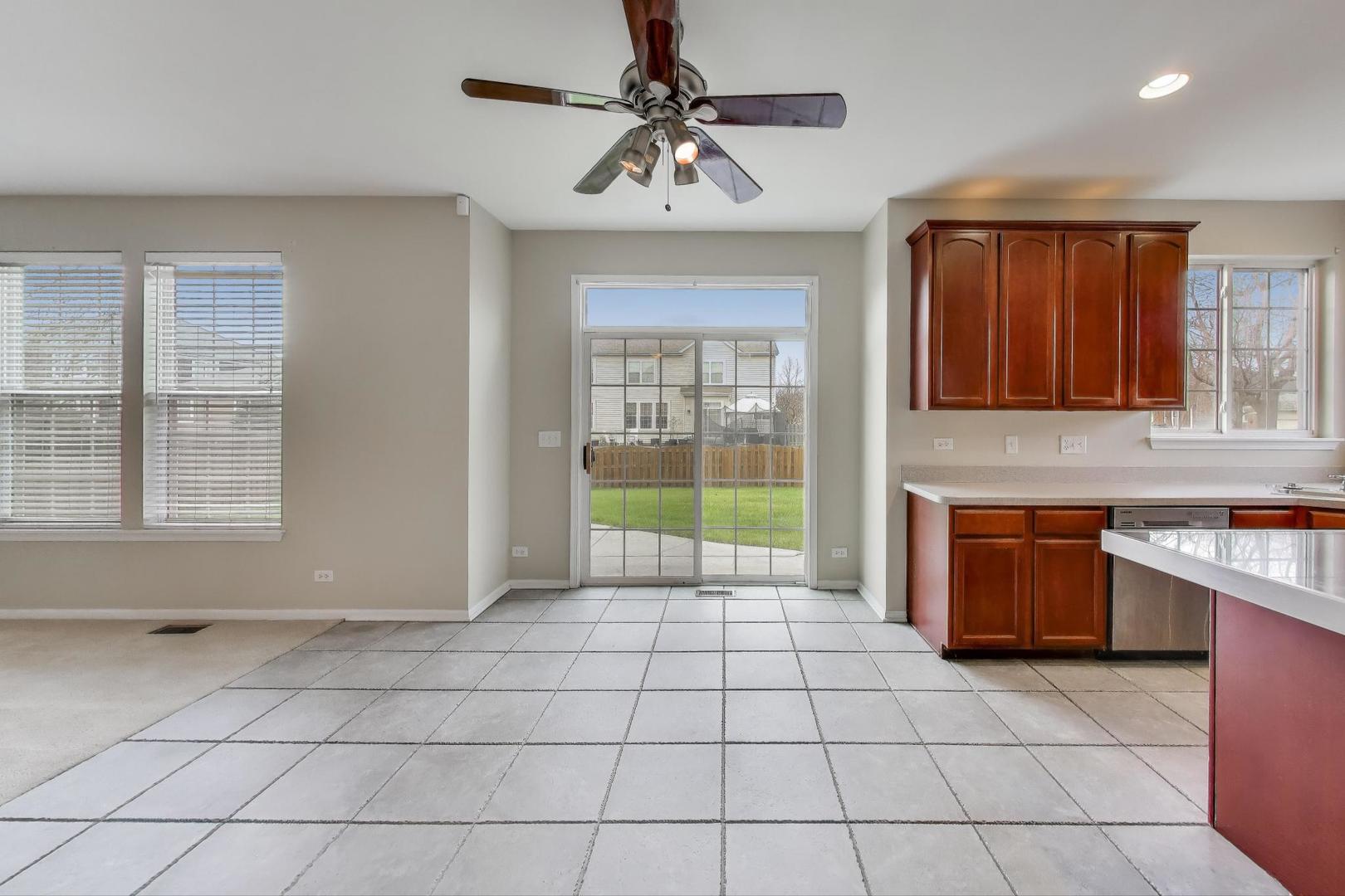 9699 Fairfield Road Huntley, IL 60142 - Photo 17 of 59 a view of a kitchen with a sink and a microwave
