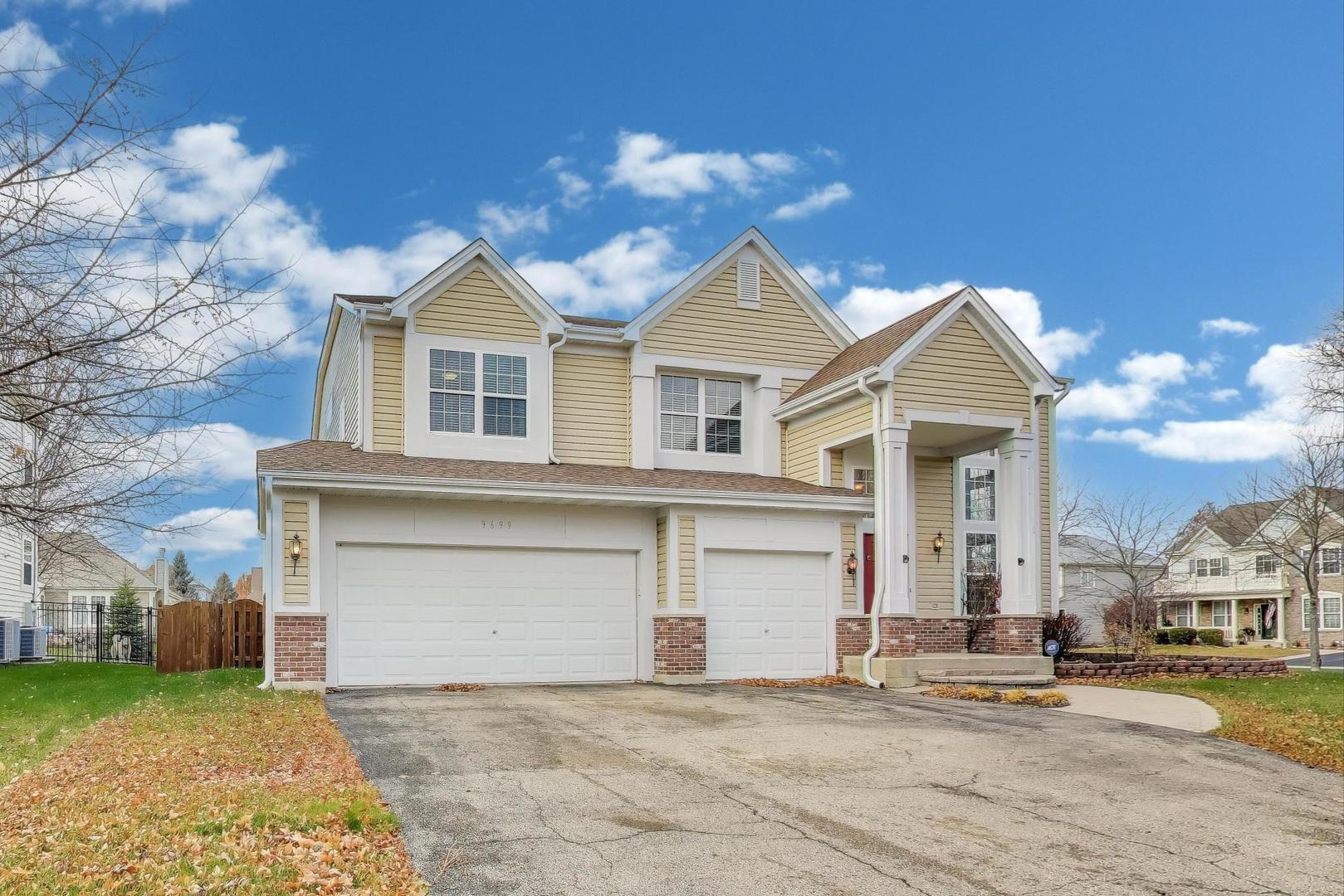 9699 Fairfield Road Huntley, IL 60142 - Photo 2 of 59 a front view of a house with a garden and yard