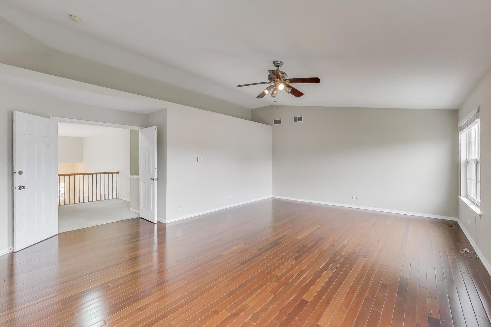 9699 Fairfield Road Huntley, IL 60142 - Photo 25 of 59 a view of empty room with wooden floor and fan