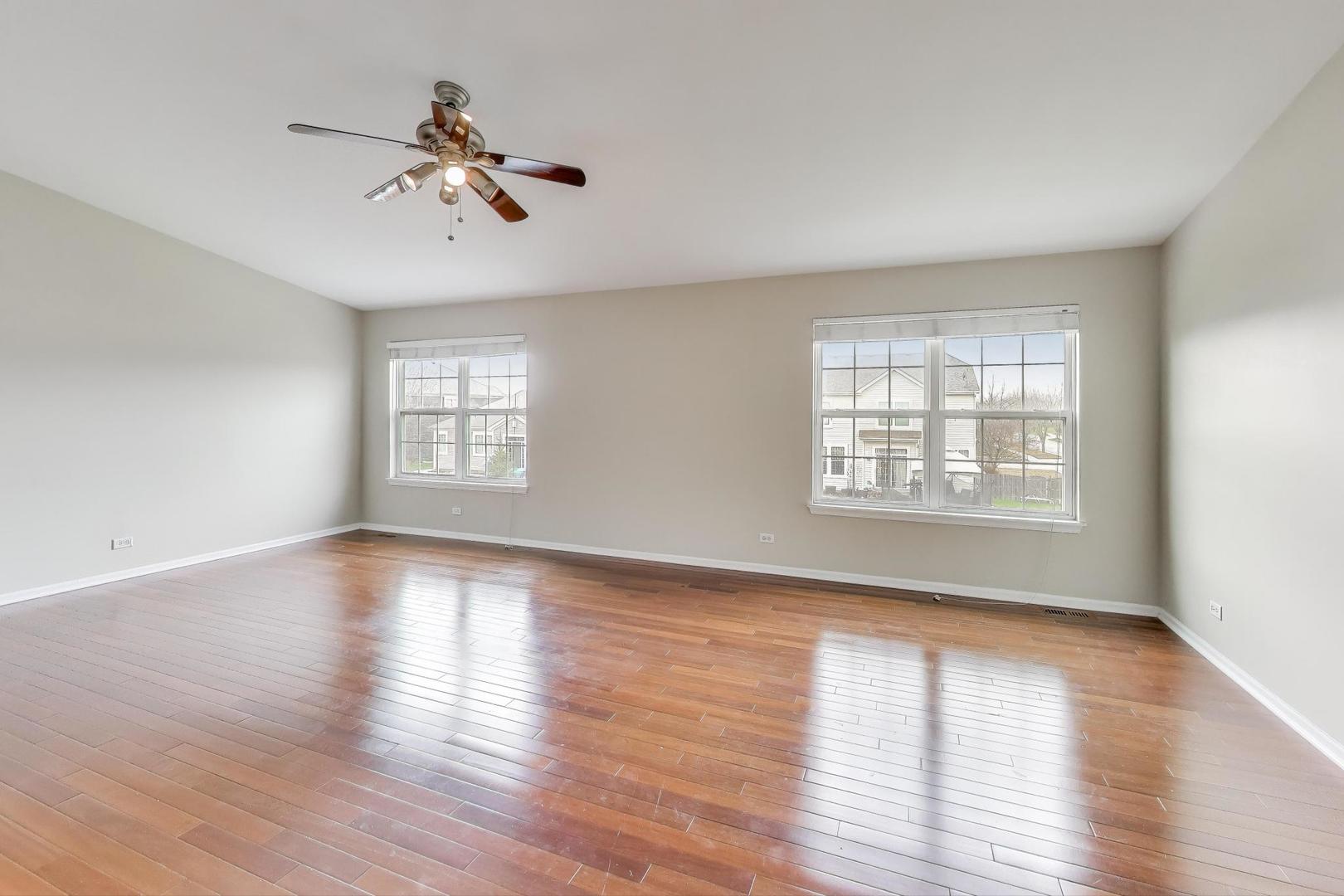 9699 Fairfield Road Huntley, IL 60142 - Photo 27 of 59 a view of an empty room with a window and wooden floor