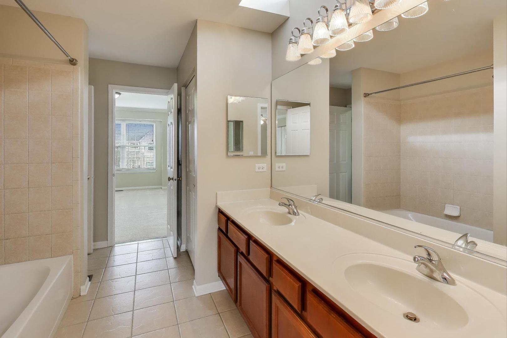 9699 Fairfield Road Huntley, IL 60142 - Photo 35 of 59 a spacious bathroom with a double vanity sink mirror and shower