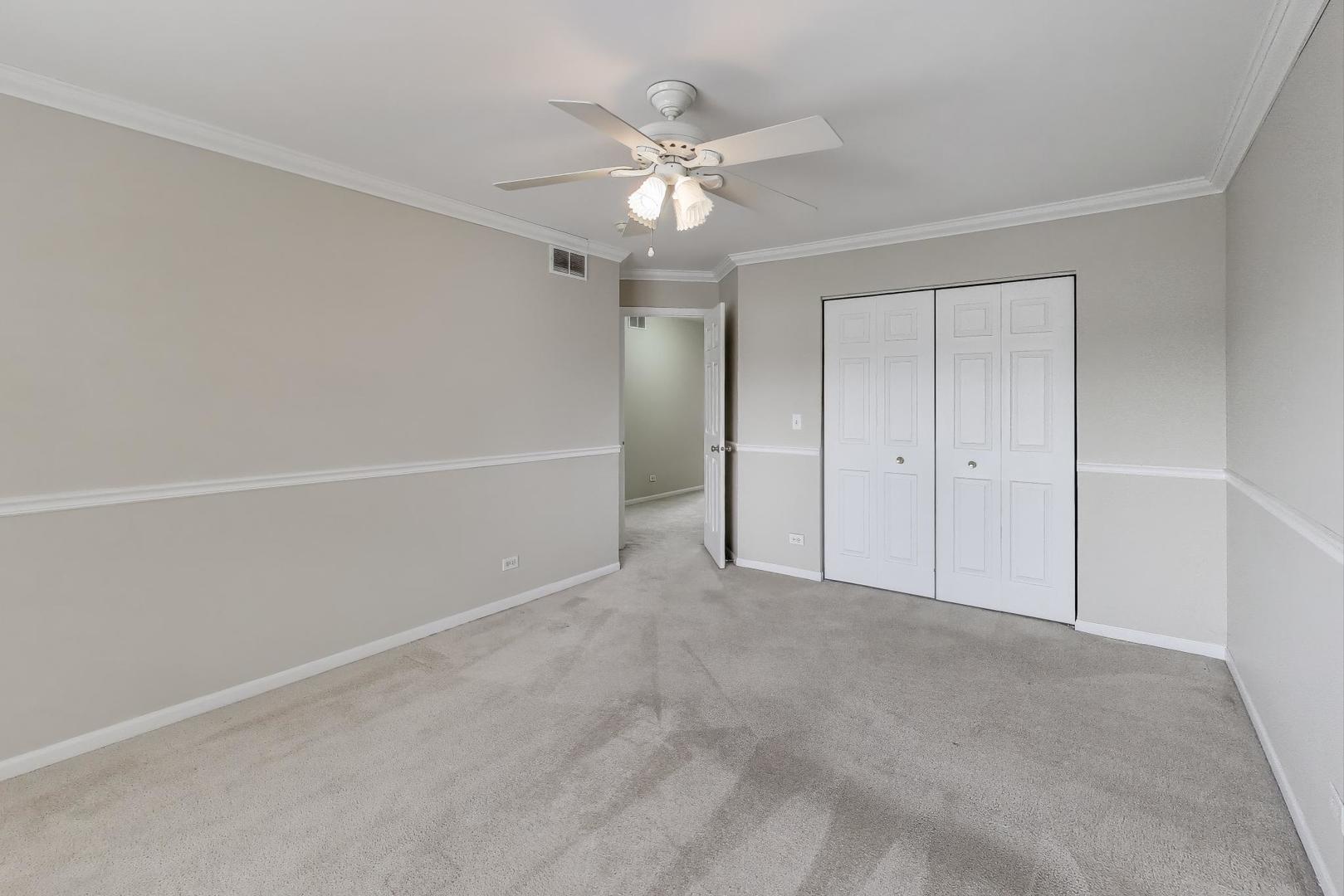 9699 Fairfield Road Huntley, IL 60142 - Photo 38 of 59 a view of an empty room with a ceiling fan