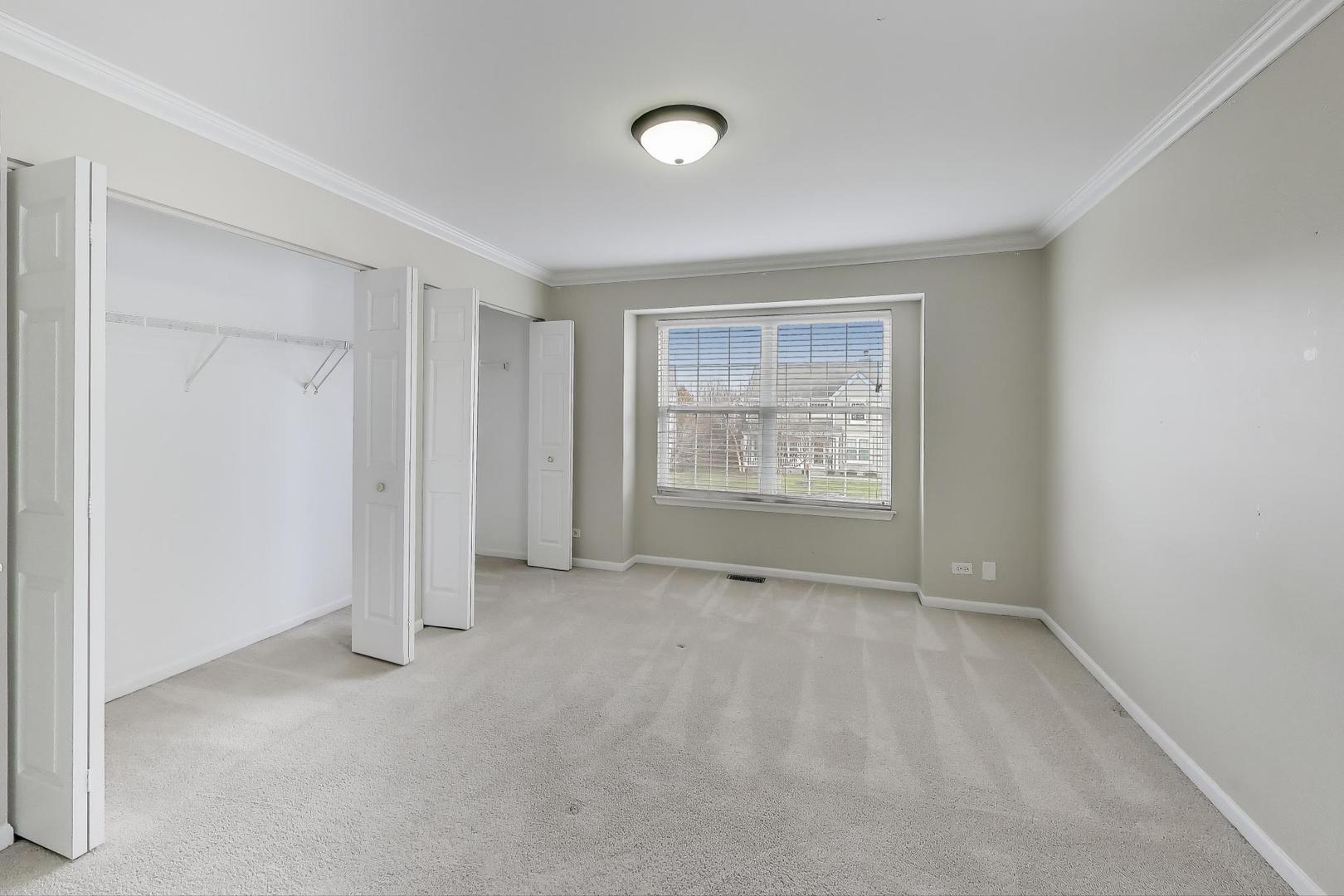 9699 Fairfield Road Huntley, IL 60142 - Photo 39 of 59 an empty room with windows and closet