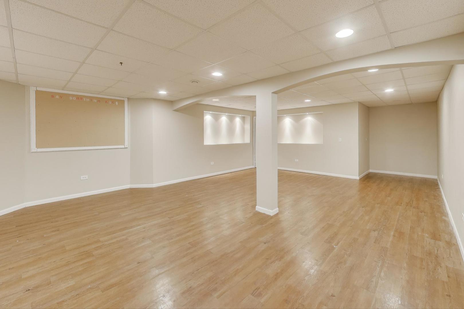 9699 Fairfield Road Huntley, IL 60142 - Photo 41 of 59 a view of an empty room with wooden floor and a window