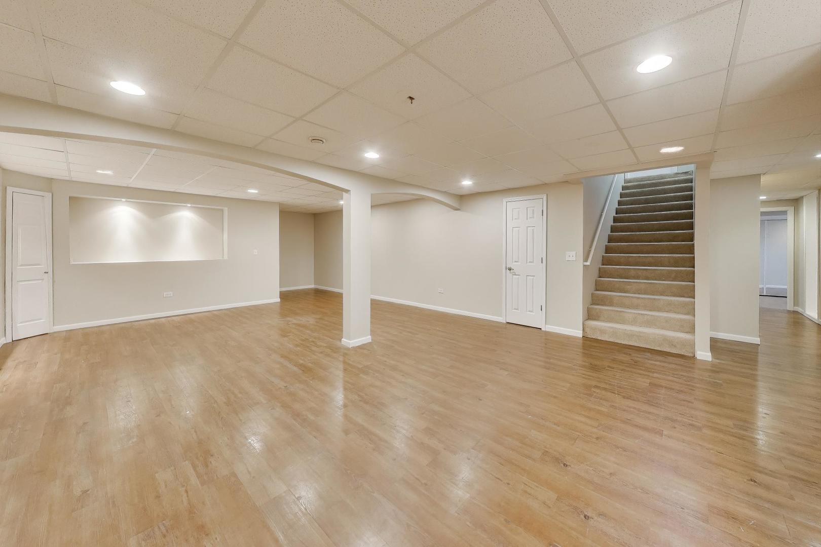 9699 Fairfield Road Huntley, IL 60142 - Photo 42 of 59 a view of an empty room with wooden floor