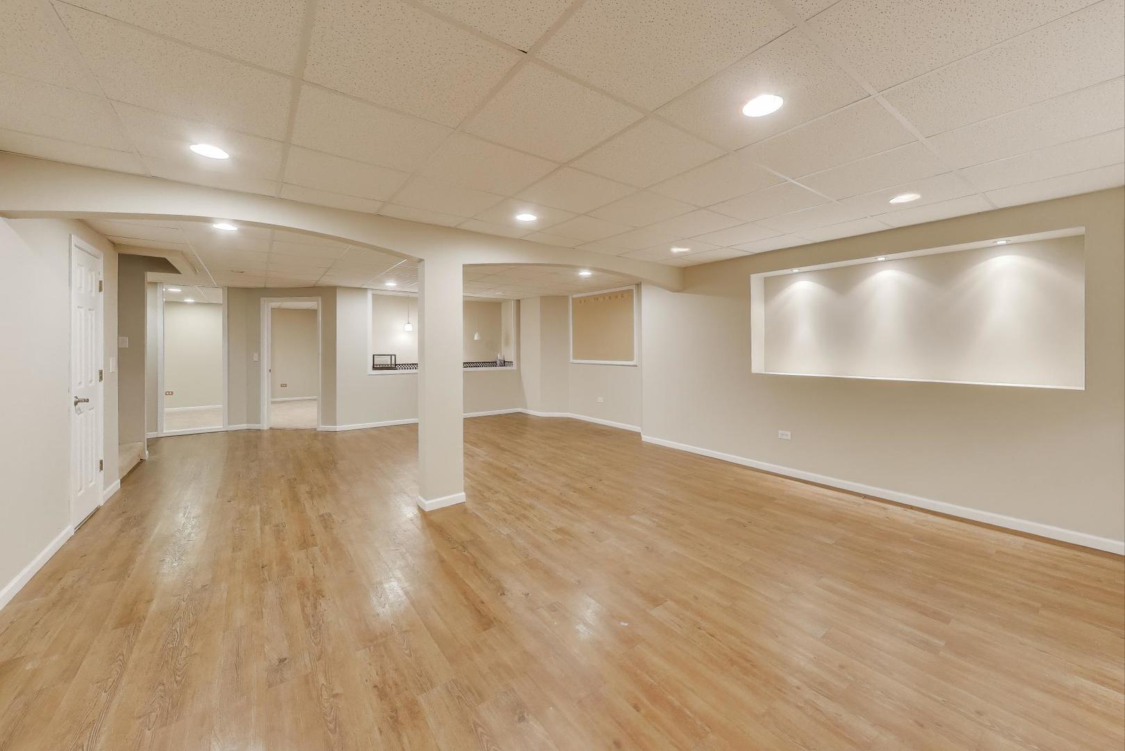 9699 Fairfield Road Huntley, IL 60142 - Photo 43 of 59 a view of an empty room with wooden floor