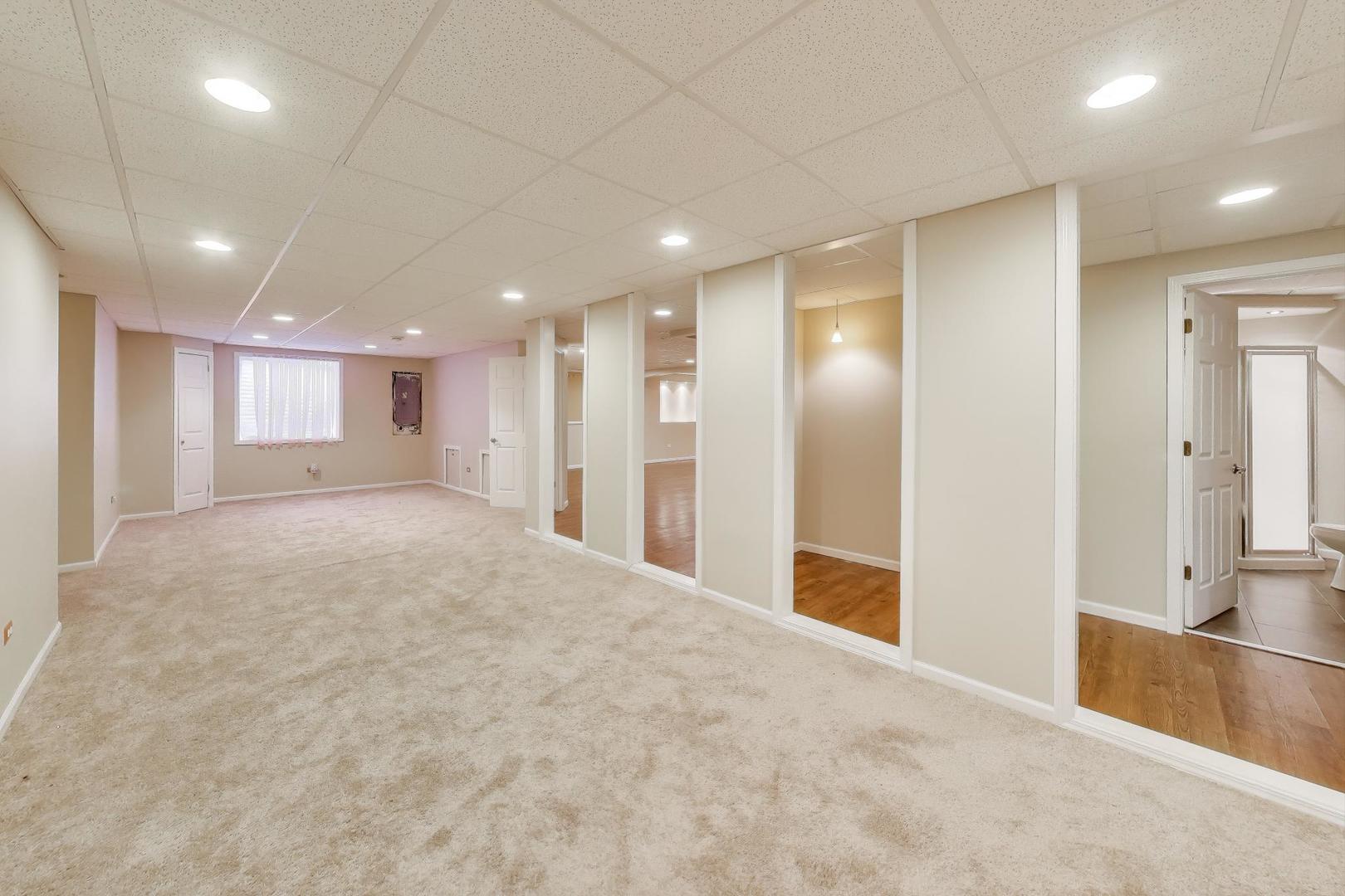 9699 Fairfield Road Huntley, IL 60142 - Photo 45 of 59 a view of an empty room with wooden floor