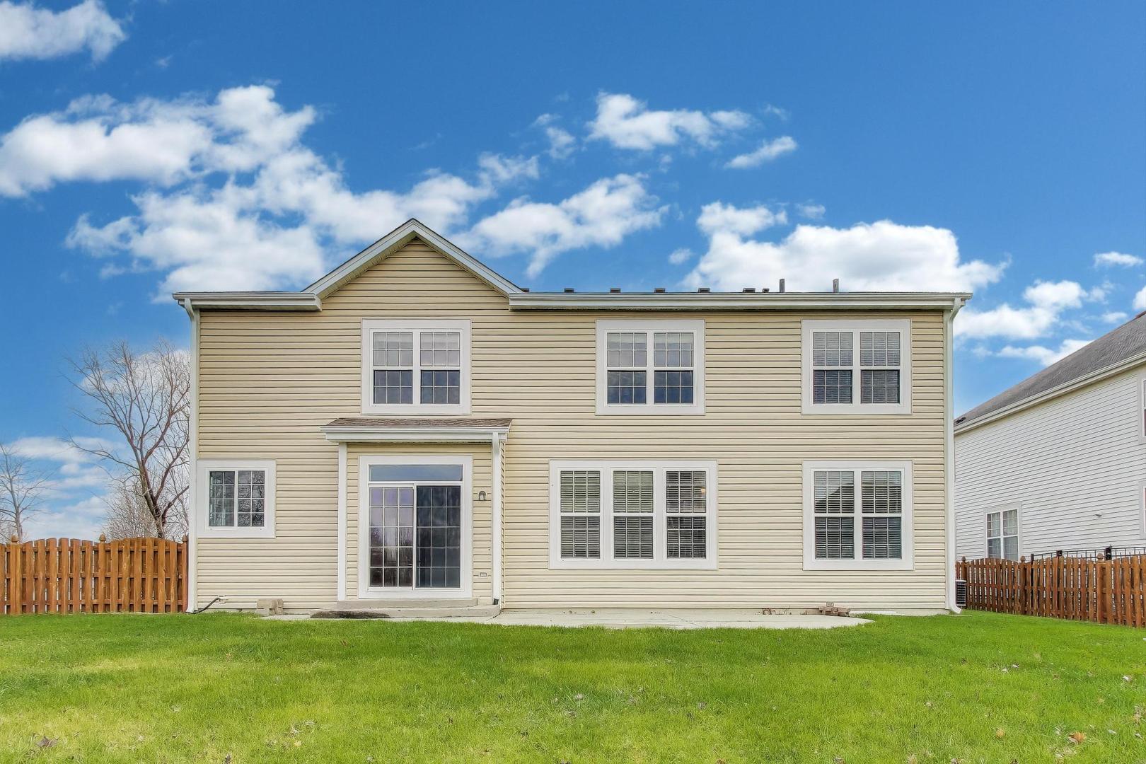 9699 Fairfield Road Huntley, IL 60142 - Photo 50 of 59 a front view of a house with a garden