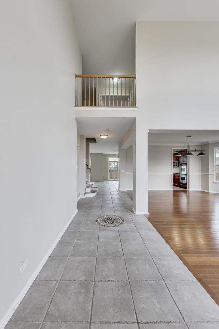9699 Fairfield Road Huntley, IL 60142 - Photo 5 of 59 a view of a hallway to a livingroom with furniture
