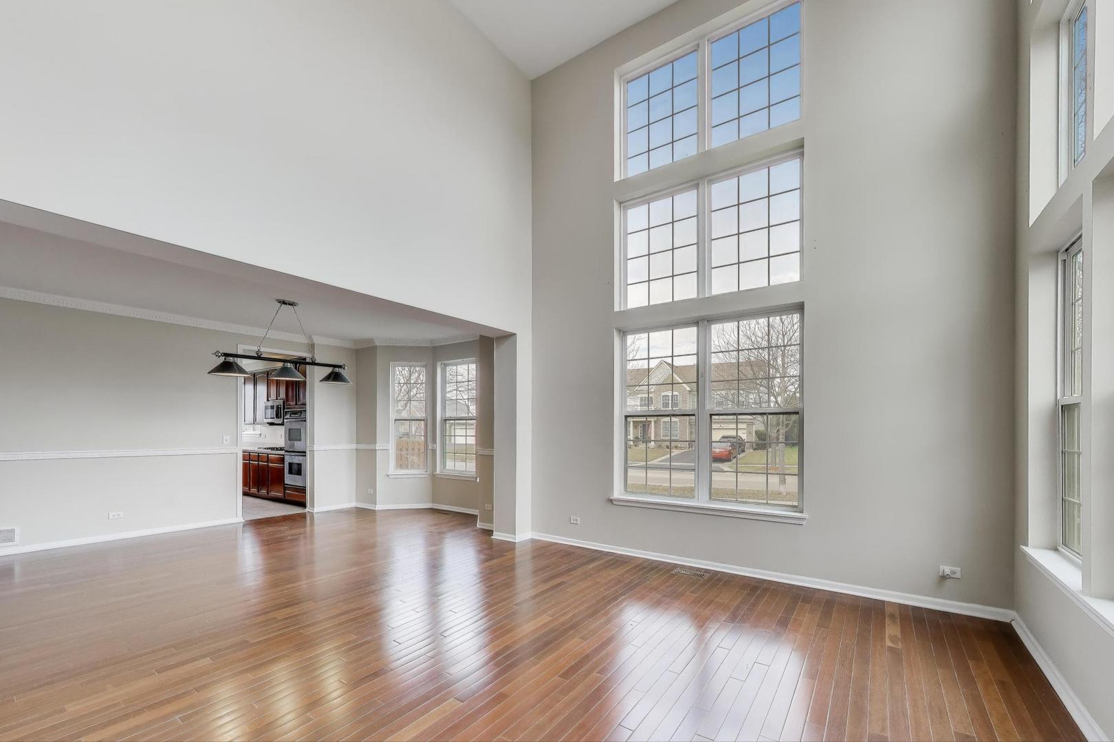 9699 Fairfield Road Huntley, IL 60142 - Photo 6 of 59 wooden floor in an empty room with a window