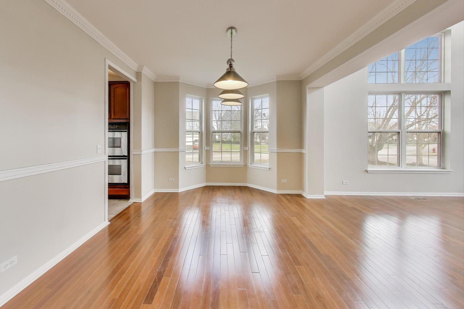 9699 Fairfield Road Huntley, IL 60142 - Photo 8 of 59 wooden floor in an empty room with a window