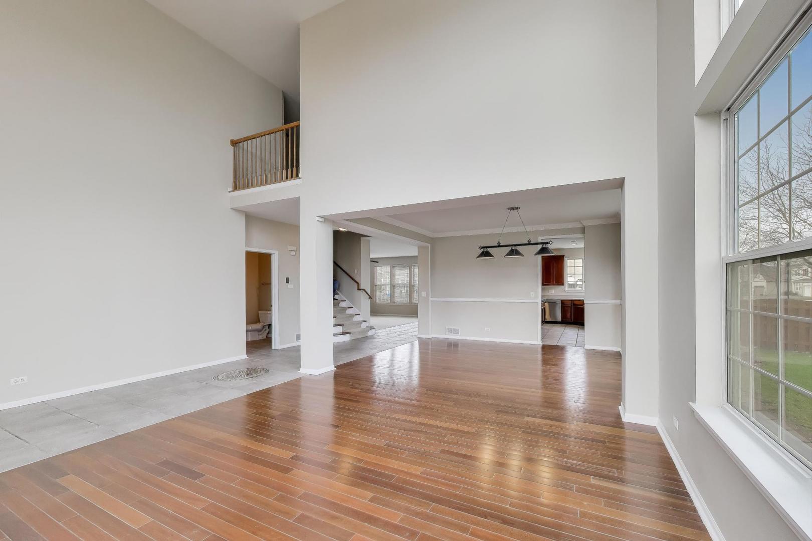9699 Fairfield Road Huntley, IL 60142 - Photo 10 of 59 a view of empty room with wooden floor and fireplace