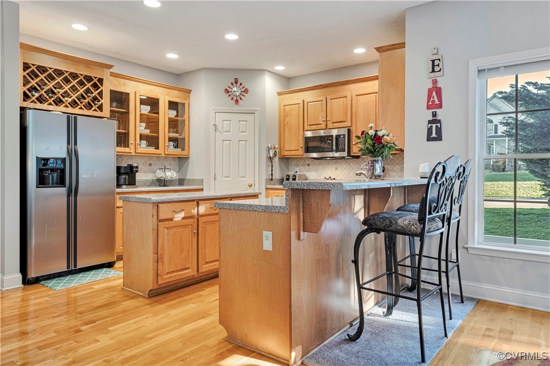 5000 Faraday Drive Chester, VA 23831 - Photo 16 of 40 a kitchen with stainless steel appliances granite countertop a refrigerator a stove and a dining table with wooden floor