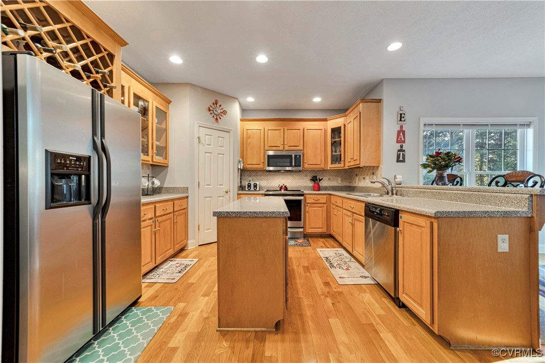 5000 Faraday Drive Chester, VA 23831 - Photo 17 of 40 a kitchen with stainless steel appliances granite countertop a refrigerator a sink dishwasher a stove and a dining table with wooden floor