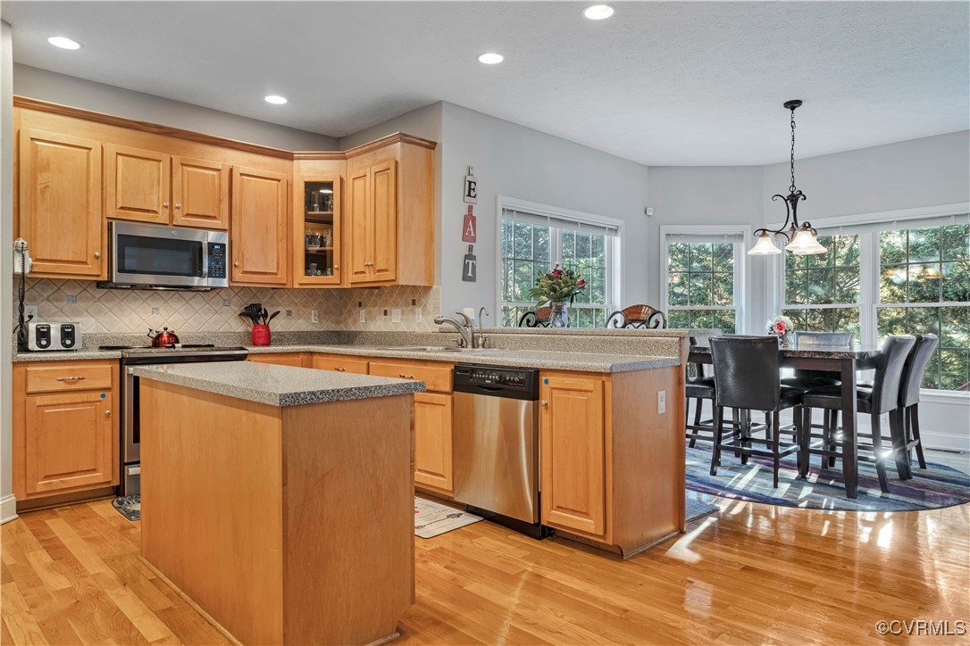 5000 Faraday Drive Chester, VA 23831 - Photo 19 of 40 a kitchen with stainless steel appliances granite countertop a stove top oven a sink a dining table and chairs