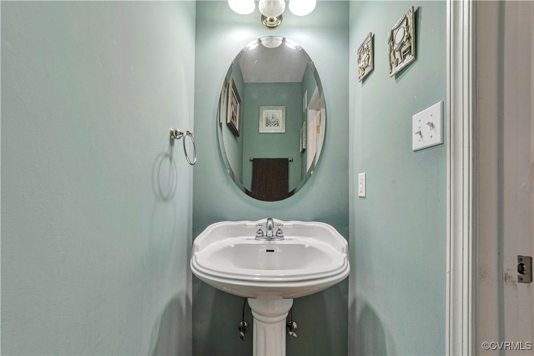 5000 Faraday Drive Chester, VA 23831 - Photo 22 of 40 a bathroom with a sink and mirror