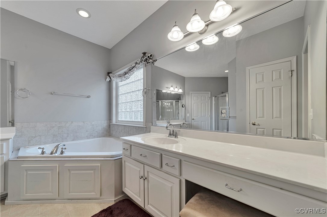 5000 Faraday Drive Chester, VA 23831 - Photo 27 of 40 a bathroom with a sink a large mirror and a bathtub