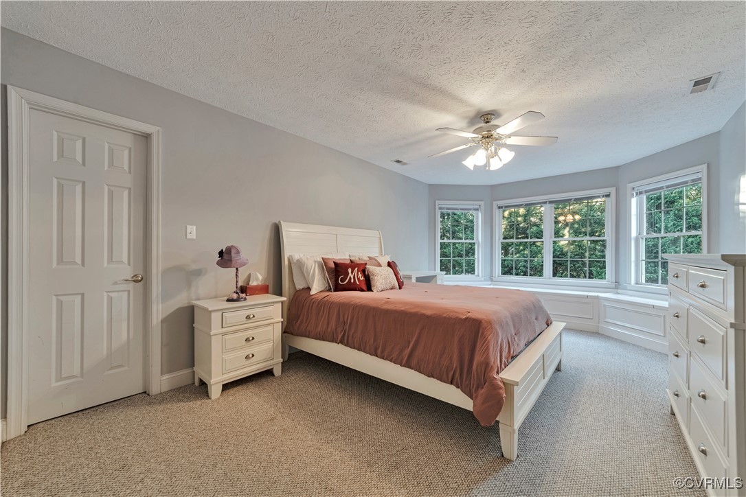 5000 Faraday Drive Chester, VA 23831 - Photo 33 of 40 a bed room with a bed and a chandelier