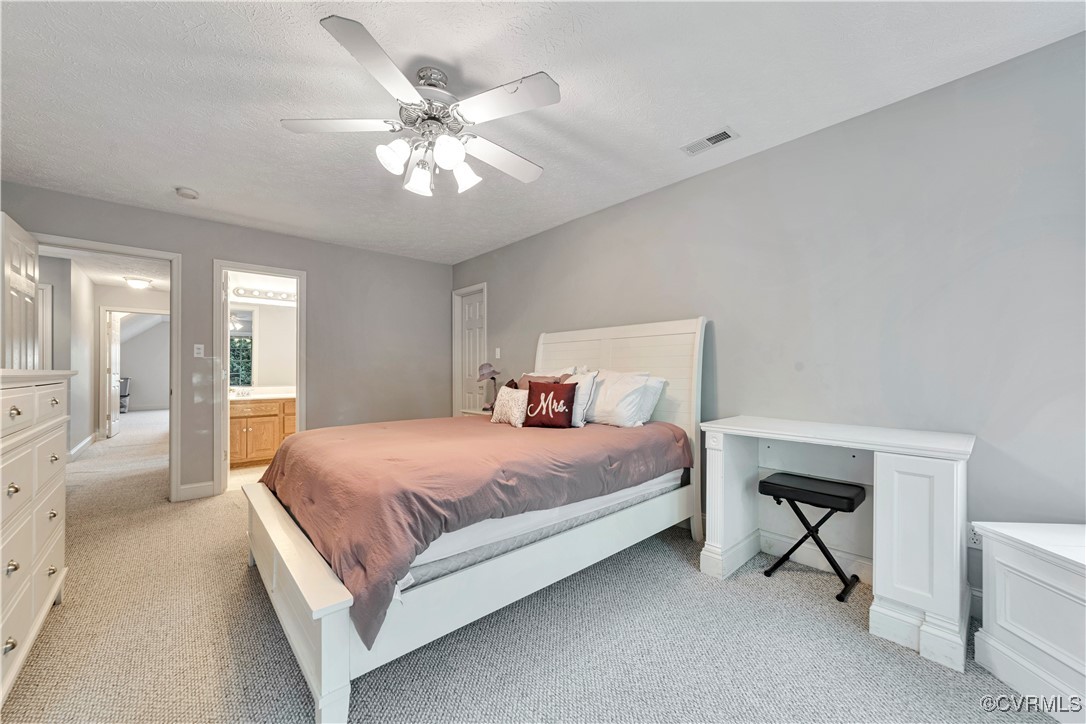 5000 Faraday Drive Chester, VA 23831 - Photo 34 of 40 a bedroom with a bed and a chandelier