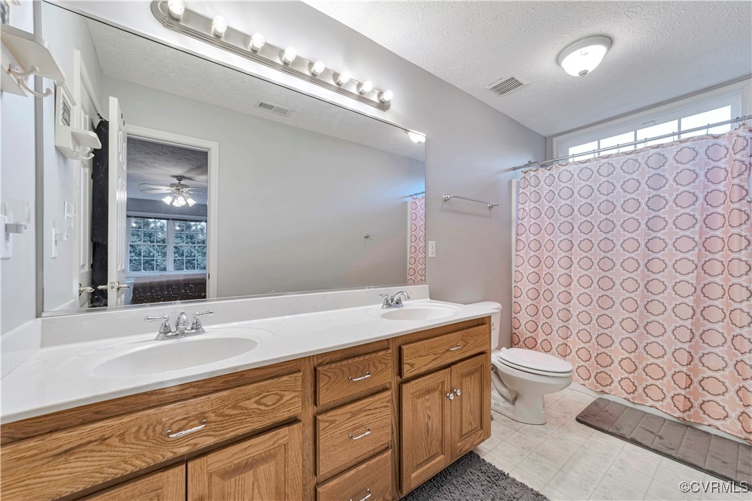 5000 Faraday Drive Chester, VA 23831 - Photo 35 of 40 a bathroom with a double vanity sink mirror and toilet