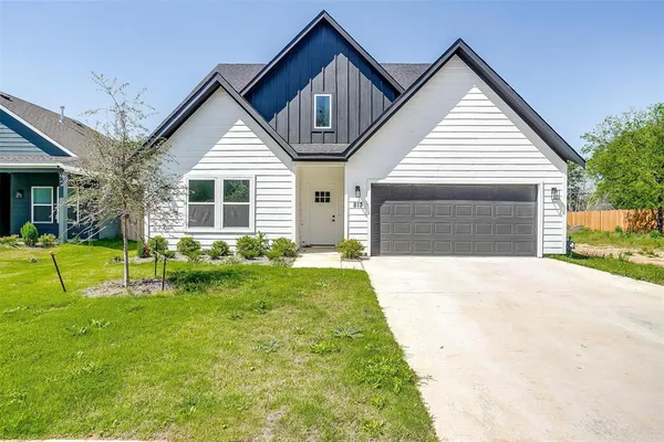 a front view of house with yard and green space