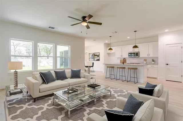a living room with furniture and a large window