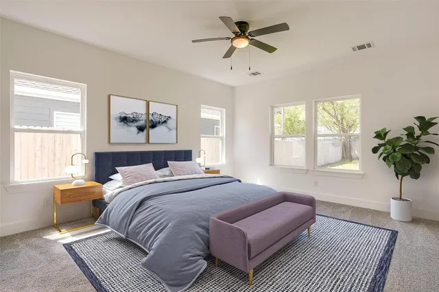 a bedroom with a large bed a chandelier and a window