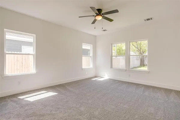 a view of room with a ceiling fan and window