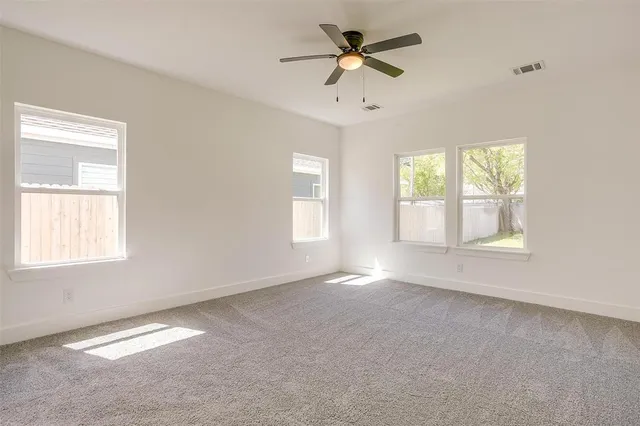 a view of room with a ceiling fan and window
