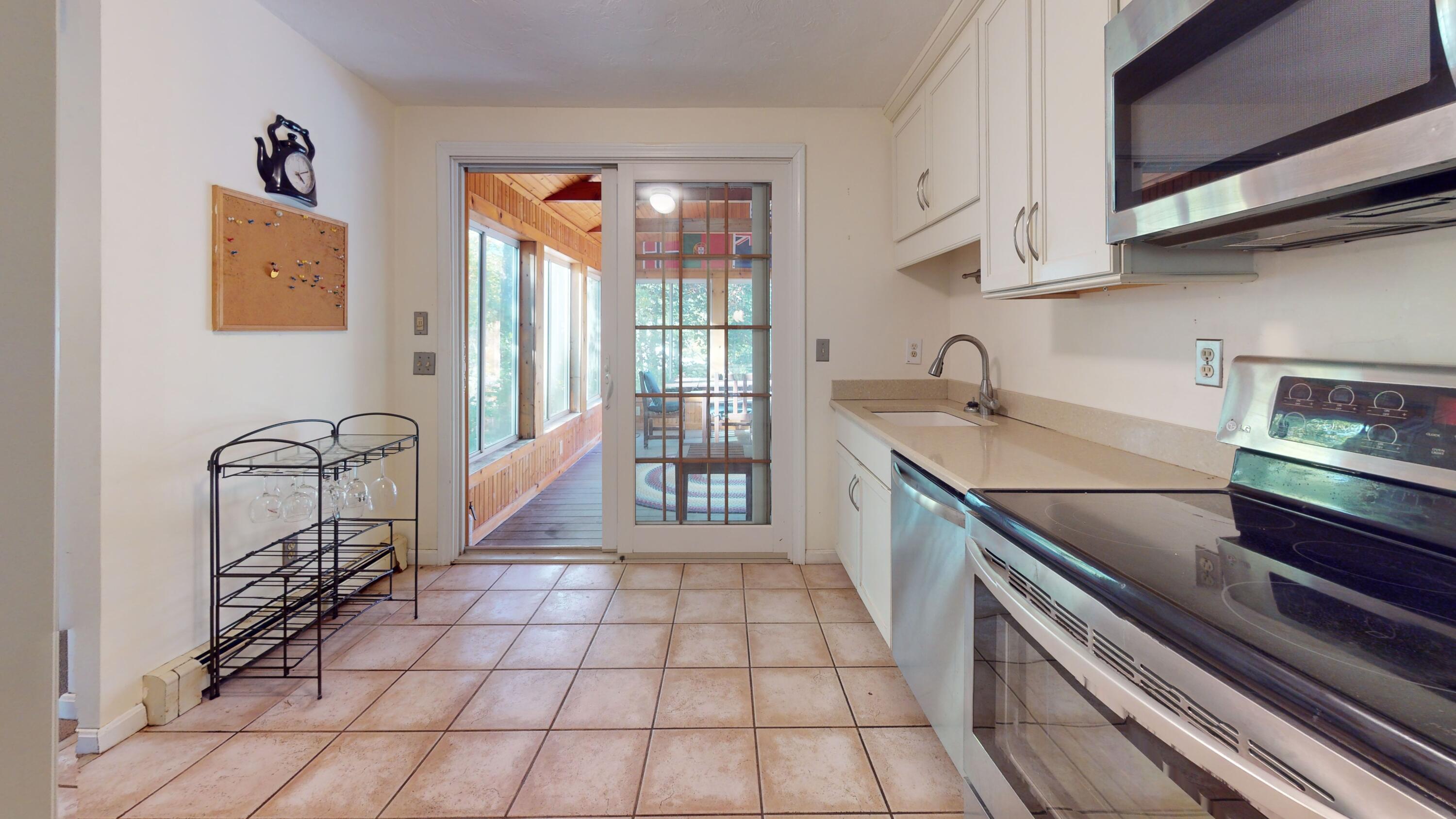 17 Toms Path Dennis Port, MA 02639 - Photo 7 of 31 a kitchen with granite countertop a sink a stove and cabinets