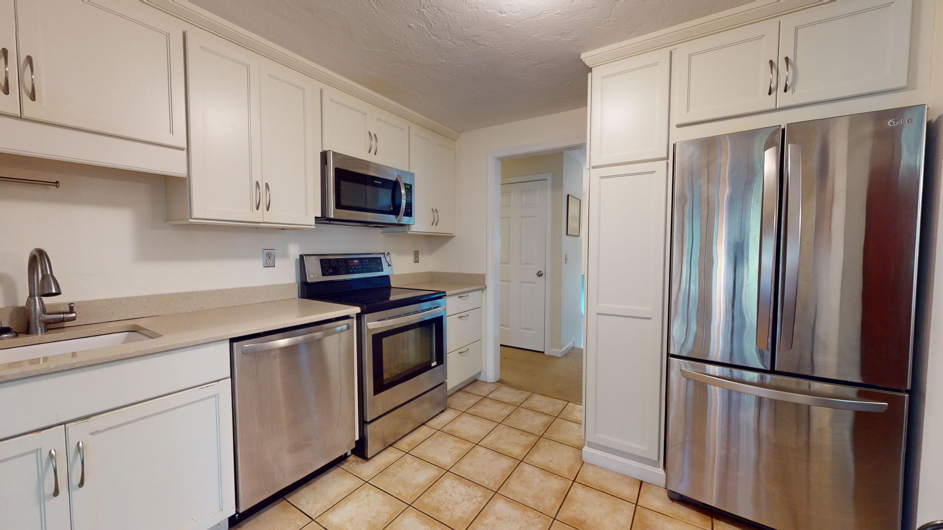 17 Toms Path Dennis Port, MA 02639 - Photo 8 of 31 a kitchen with stainless steel appliances granite countertop a refrigerator sink and stove