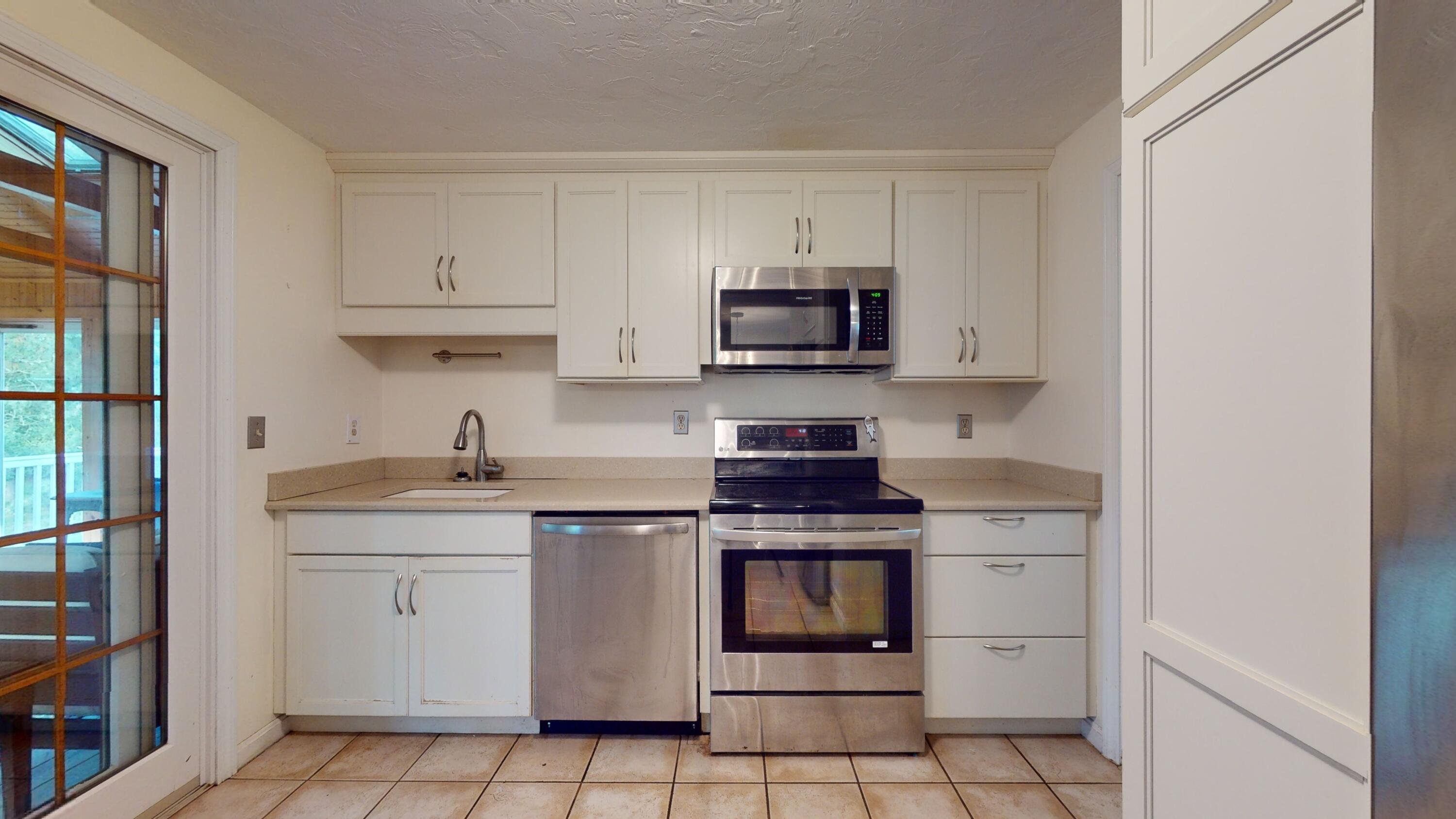 17 Toms Path Dennis Port, MA 02639 - Photo 9 of 31 a kitchen with stainless steel appliances a sink stove and cabinets