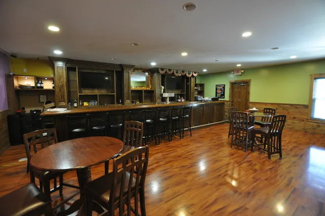 a kitchen with stainless steel appliances dining table and chairs