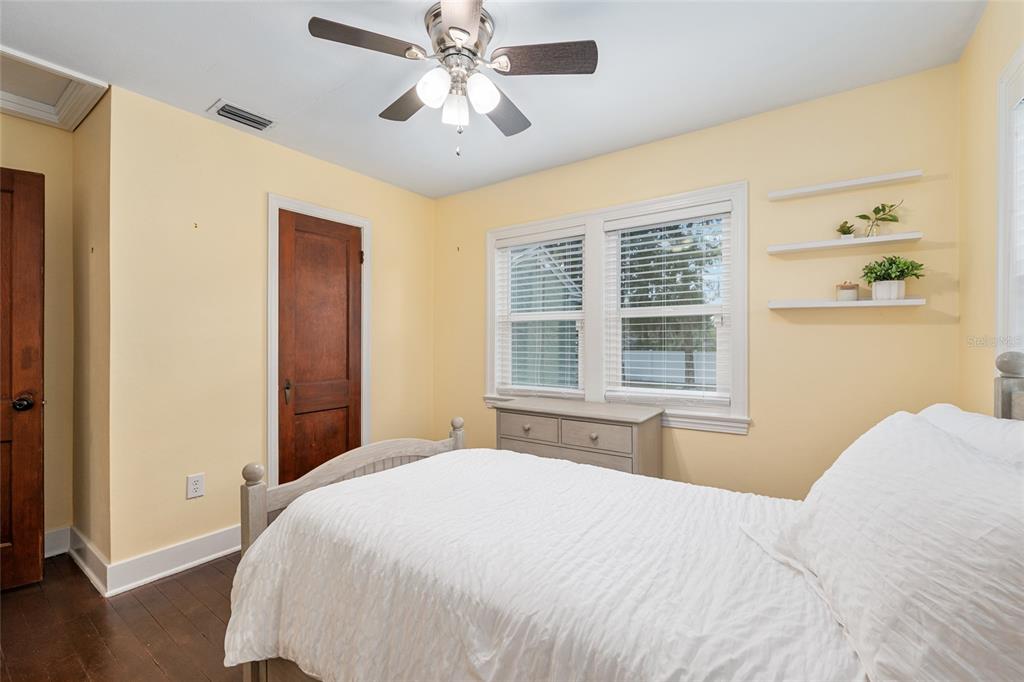 742 Southeast 12th Street Ocala, FL 34471 - Photo 19 of 44 a bedroom with a large bed and wooden floor