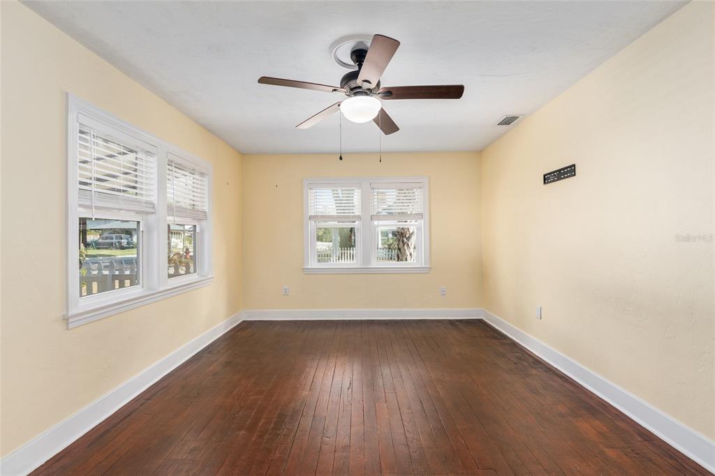742 Southeast 12th Street Ocala, FL 34471 - Photo 7 of 44 wooden floor in an empty room with a window