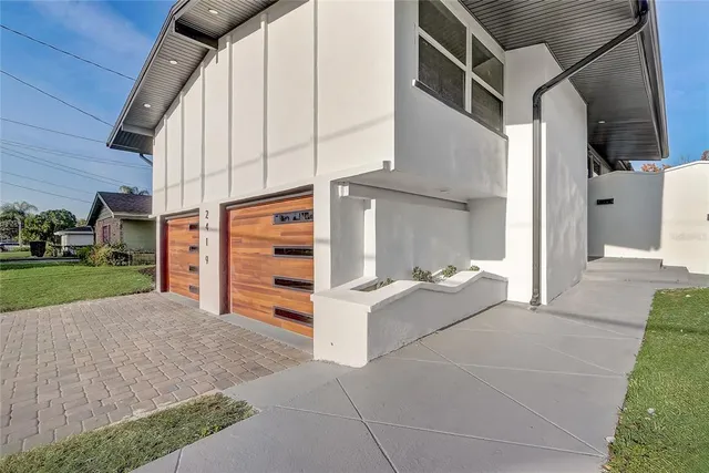 a living room with furniture kitchen area and a chandelier