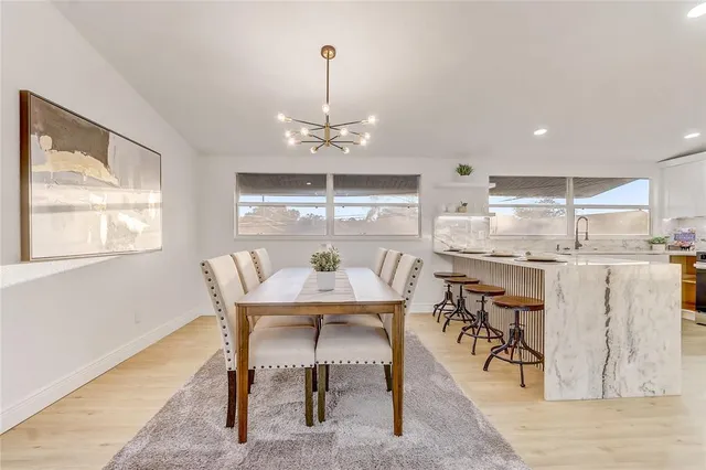 a living room with furniture a table and a large window