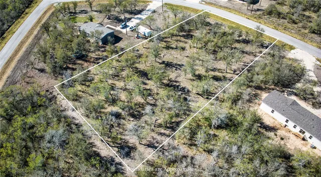 an aerial view of a house with a yard