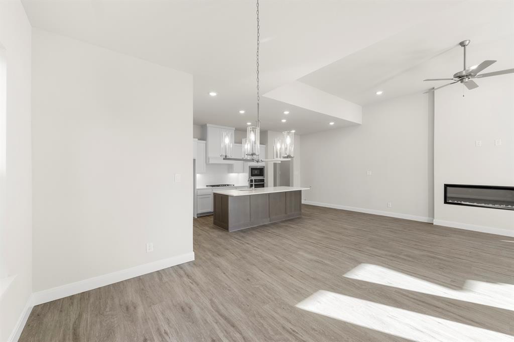 1201 Century Tree Lane Anna, TX 75409 - Photo 11 of 26 a large kitchen with cabinets wooden floor and a stainless steel appliances