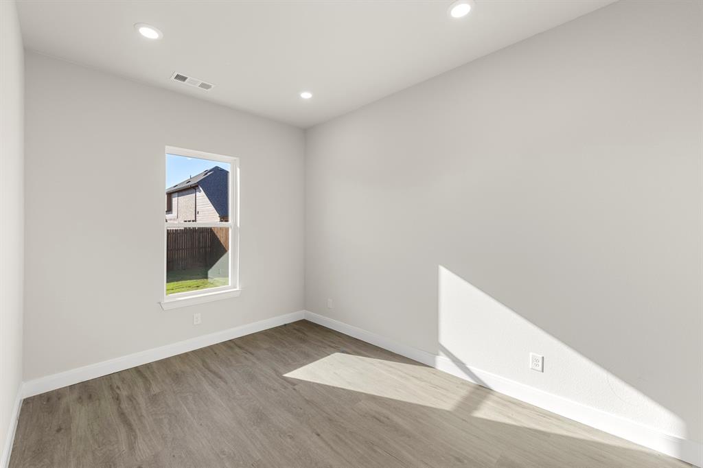 1201 Century Tree Lane Anna, TX 75409 - Photo 12 of 26 a view of an empty room with wooden floor and a window