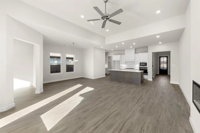 a view of kitchen with refrigerator stove and wooden floor
