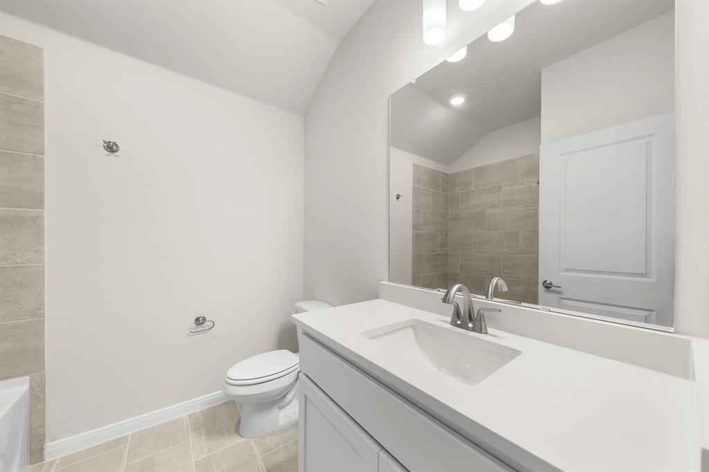 1201 Century Tree Lane Anna, TX 75409 - Photo 23 of 26 a bathroom with a sink a toilet and a mirror